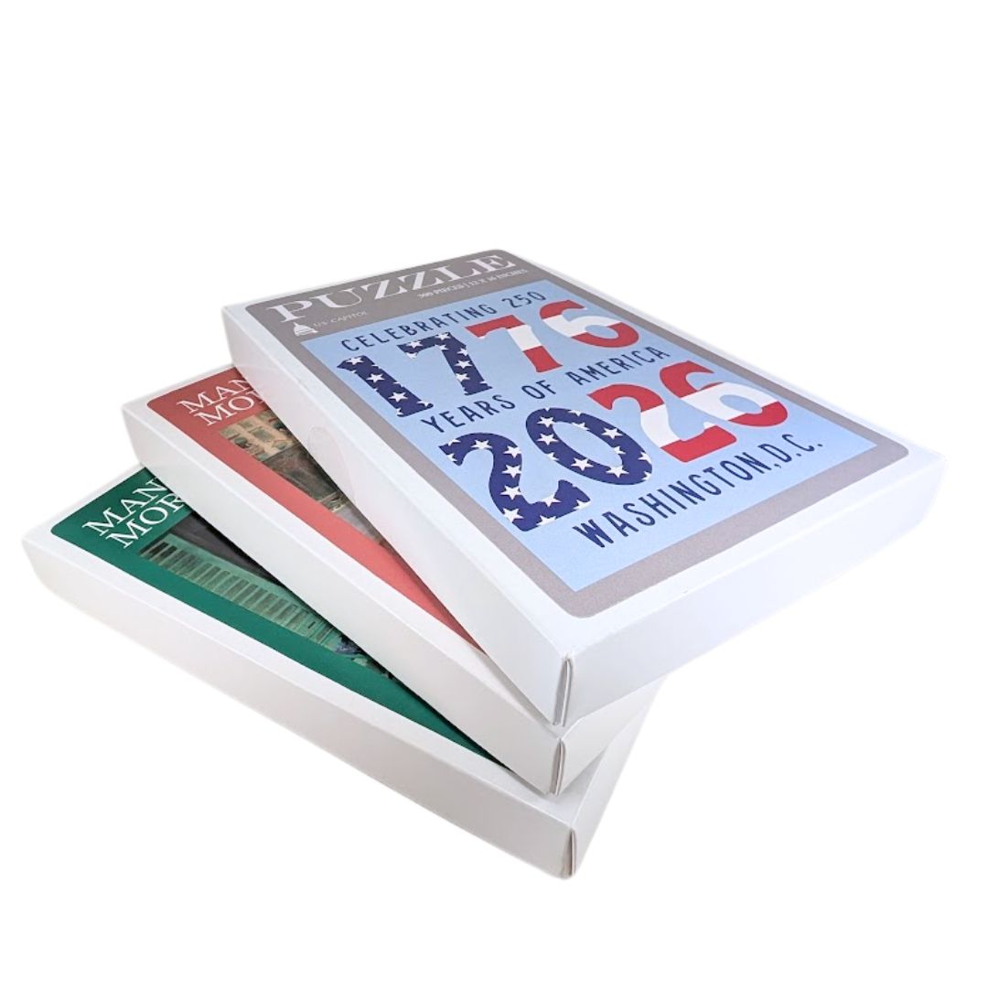 Stack of three white museum puzzle boxes in different sizes.